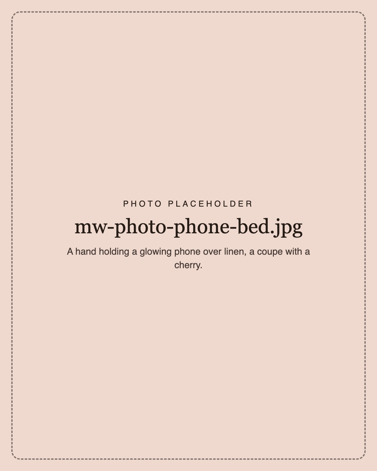 A hand holding a glowing phone over linen sheets in morning light